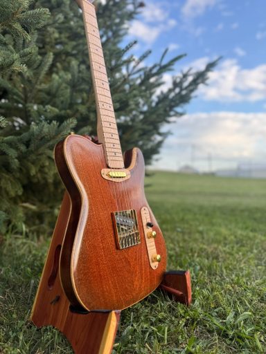 Acoustic guitar with flame inlays on the fretboard